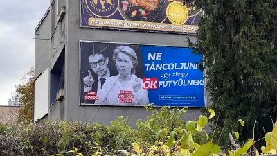 Government billboard showing Alex Soros and Ursula von der Leyen beside the slogan 'Let's not dance as they whistle'.